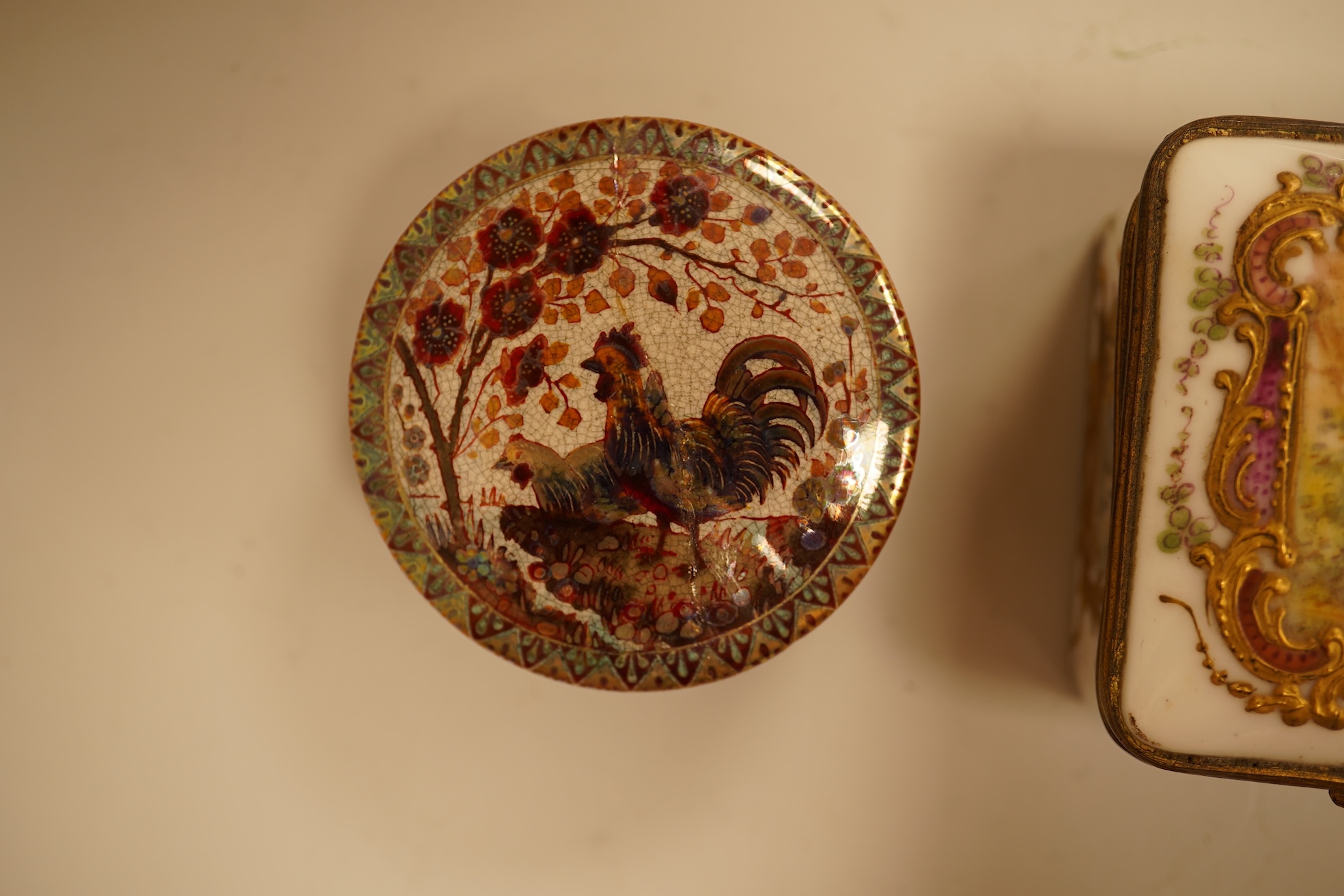 A Zsolnay lustre 'chicken' box and cover and two Sevres style porcelain boxes and covers (3) ‘chicken box’ 5cm diameter.